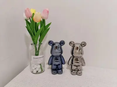 two figurines and a vase with flowers on a shelf at PWTC Titiwangsa HKL near MRT family in Kuala Lumpur