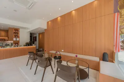 a dining room with tables and chairs and a kitchen at STAYS HOTEL in Kuala Lumpur