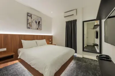 a bedroom with a bed and a large mirror at STAYS HOTEL in Kuala Lumpur