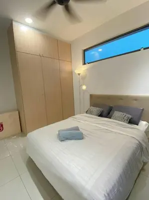 a bedroom with a white bed with a ceiling fan at LOVELy Home For Small Family@KL in Kuala Lumpur