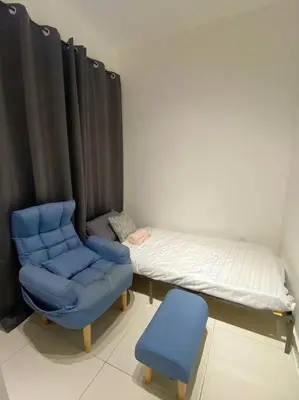 a bedroom with a bed and a blue chair at LOVELy Home For Small Family@KL in Kuala Lumpur