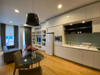 a living room with a table and a kitchen at Platinum KLCC & Bukit Bintang in Kuala Lumpur