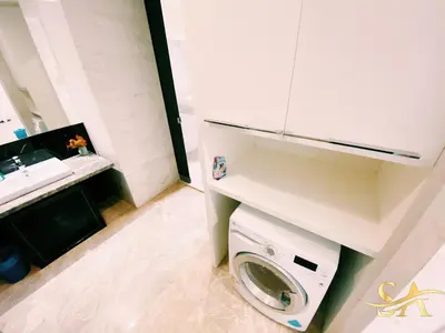 a bathroom with a washing machine and a sink at Platinum KLCC & Bukit Bintang in Kuala Lumpur