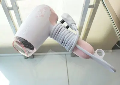 a pink and white hair dryer sitting on a mirror at Couple Suite at Casa Mutiara 5 mins walk to LRT, Jalan Alor and Bukit Bintang in Kuala Lumpur