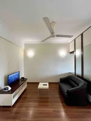 a living room with a black couch and a ceiling fan at Couple Suite at Casa Mutiara 5 mins walk to LRT, Jalan Alor and Bukit Bintang in Kuala Lumpur