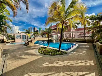 a resort with a swimming pool and palm trees at Couple Suite at Casa Mutiara 5 mins walk to LRT, Jalan Alor and Bukit Bintang in Kuala Lumpur