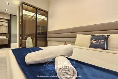 a hotel room with a bed with a towel on it at Expressionz Premium Suites @ KLCC in Kuala Lumpur