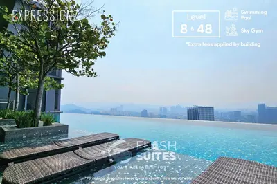 a swimming pool with two benches on top of a building at Expressionz Premium Suites @ KLCC in Kuala Lumpur