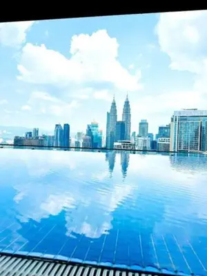 a view of a city skyline from a swimming pool at Maxhome at The Luxe By Infinitum in Kuala Lumpur