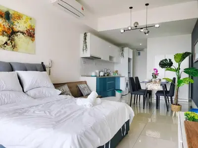 a bedroom with a large bed and a dining room at City-View Studio Retreat with Spectacular View TRX in Kuala Lumpur