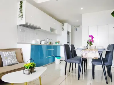a kitchen and living room with a table and chairs at City-View Studio Retreat with Spectacular View TRX in Kuala Lumpur