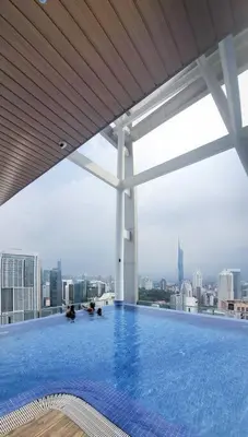 a swimming pool on top of a building with a city skyline at CLS 16B KLCC Balcony View Studio in Kuala Lumpur