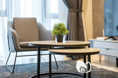 a table and a chair with a potted plant on it at Sentral Suites by Plush in Kuala Lumpur
