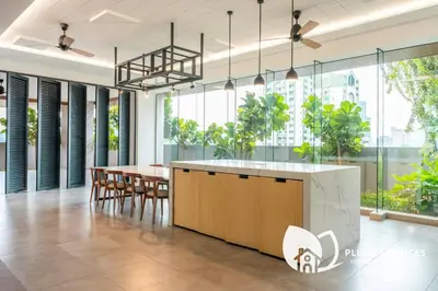 a dining room with a table and chairs and windows at Sentral Suites by Plush in Kuala Lumpur