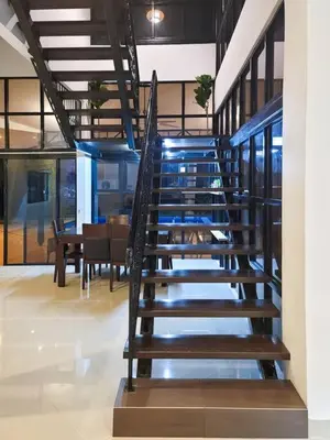 a spiral staircase in a building with a dining room at Titiwangsa9 Bungalow Pool Villa in Kuala Lumpur