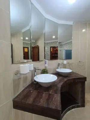 a bathroom with two sinks and a large mirror at Titiwangsa9 Bungalow Pool Villa in Kuala Lumpur