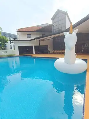 a swimming pool with a figurine of a cow on a buoy in the water at Titiwangsa9 Bungalow Pool Villa in Kuala Lumpur