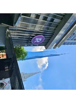a purple sign hanging from the side of a building at The Robertson Bukit Bintang Kuala Lumpur by Cloud Host in Kuala Lumpur