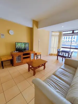a living room with a couch and a flat screen tv at Fahrenheit Pavillion Bukit Bintang By JS-Home in Kuala Lumpur