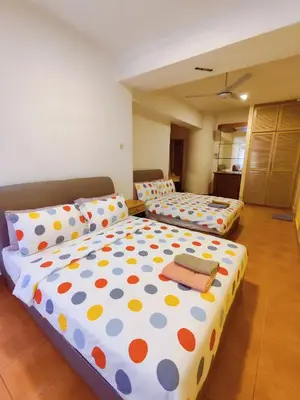 a bedroom with two beds with polka dot sheets at Fahrenheit Pavillion Bukit Bintang By JS-Home in Kuala Lumpur