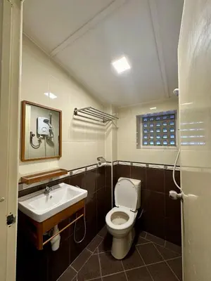a bathroom with a toilet and a sink at Hotel Arba in Kuala Lumpur