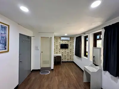 a hallway with a door and a table in a room at Hotel Arba in Kuala Lumpur