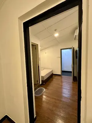a room with a bedroom with a bed and a wooden floor at Hotel Arba in Kuala Lumpur