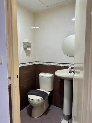 a bathroom with a toilet and a sink at Hotel Arba in Kuala Lumpur