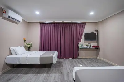 a hotel room with a bed and a purple curtain at HOTEL 28 RAPID in Kuala Lumpur