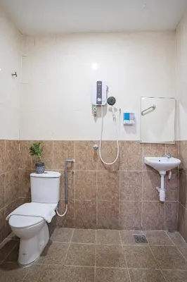 a bathroom with a shower and a toilet and a sink at HOTEL 28 RAPID in Kuala Lumpur