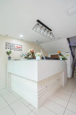 a restaurant with a counter with flowers on it at HOTEL 28 RAPID in Kuala Lumpur