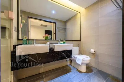 a bathroom with two sinks and a toilet at Maison 101 Dang Wangi Kuala Lumpur KLCC in Kuala Lumpur