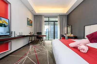 a bedroom with a bed and a desk and a television at Maison 101 Dang Wangi Kuala Lumpur KLCC in Kuala Lumpur
