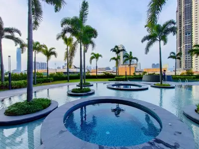 a swimming pool with palm trees in a resort at KLCity & KLCC View Modern Style 2R2B - 6 pax in Kuala Lumpur