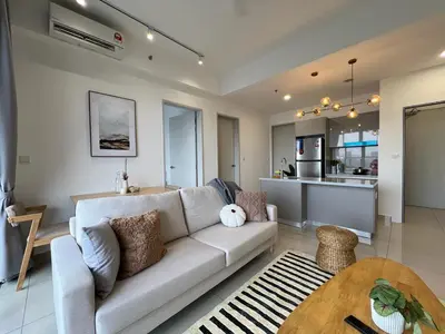 a living room with a couch and a kitchen at KLCity & KLCC View Modern Style 2R2B - 6 pax in Kuala Lumpur