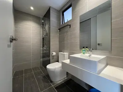a bathroom with a sink and a toilet and a mirror at KLCity & KLCC View Modern Style 2R2B - 6 pax in Kuala Lumpur