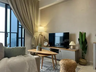 a living room with a tv and a table at KLCity & KLCC View Modern Style 2R2B - 6 pax in Kuala Lumpur