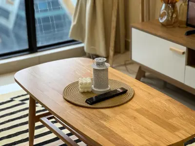 a remote control and a bottle on a table at KL City View 2R1B Free Wifi 6pax in Kuala Lumpur