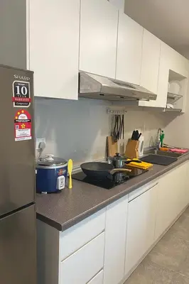 a kitchen with white cabinets and a counter top at Ooak Residence in Mont Kiara, Kuala Lumpur in Kuala Lumpur
