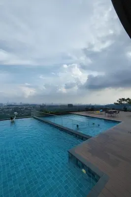 a large swimming pool on top of a building at Ooak Residence in Mont Kiara, Kuala Lumpur in Kuala Lumpur