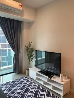 a living room with a large flat screen tv at Ooak Residence in Mont Kiara, Kuala Lumpur in Kuala Lumpur