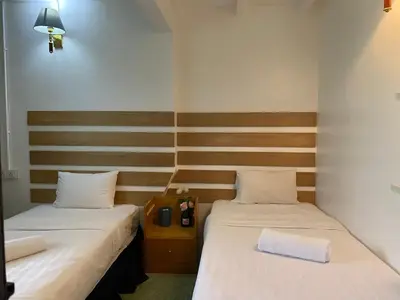 two beds in a small room with at Cheras homestay @kelian in Kuala Lumpur