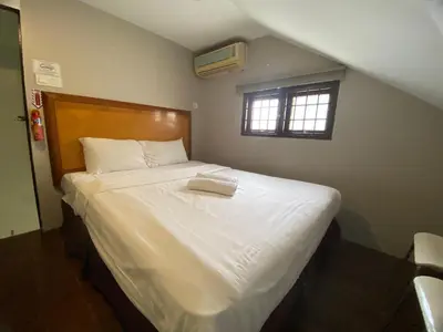 a bedroom with a large white bed with a window at Cheras homestay @kelian in Kuala Lumpur