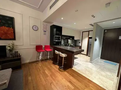 a room with a bar with red stools in it at Luxurious Condo in Heart of Kuala Lumpur with Rooftop Garden in Kuala Lumpur
