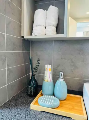 a bathroom counter with a tray with toiletries and towels at The Robertson Residence KL Bukit Bintang Chinatown Jalan Alor by \u54c1\u5c4b PINWU Shortstay in Kuala Lumpur