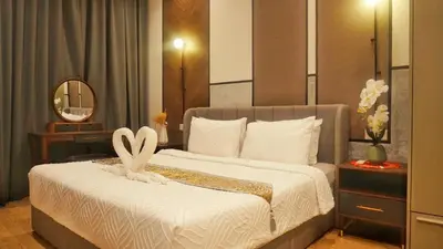 a bedroom with a large bed with a white bedspread at Lalaport Suites At Lucentia Bukit Bintang City Center in Kuala Lumpur