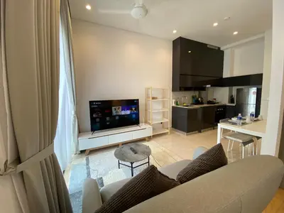 a living room with a couch and a flat screen tv at Lalaport Suites At Lucentia Bukit Bintang City Center in Kuala Lumpur