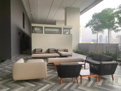 a lobby with couches and chairs on a building at Lalaport Suites At Lucentia Bukit Bintang City Center in Kuala Lumpur