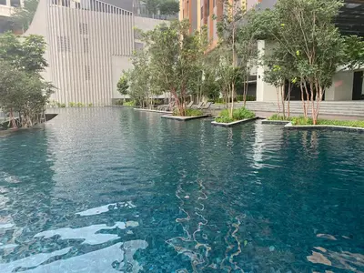a large pool of water with trees and buildings at Lalaport Suites At Lucentia Bukit Bintang City Center in Kuala Lumpur
