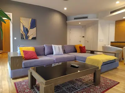a living room with a purple couch with colorful pillows at Stylish Large 3guests 1br St Mary Residences in Kuala Lumpur